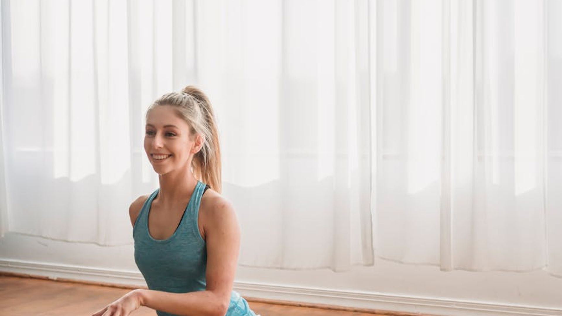 Active woman practicing gentle morning stretches in a bright room