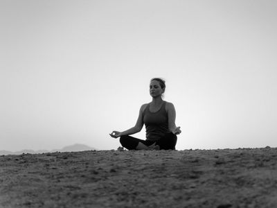 Silhouette of a person doing a balancing yoga pose